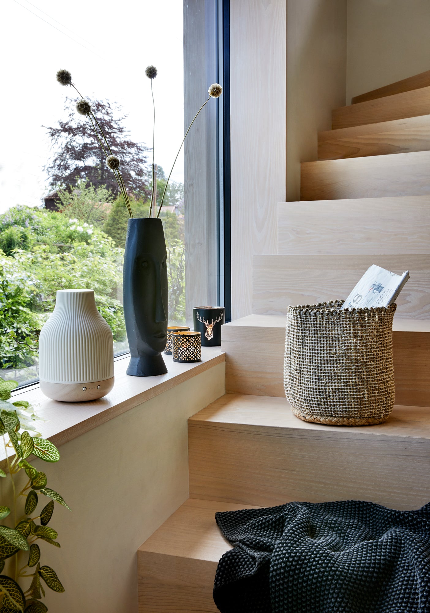 diffuser in window next to stair surrounded by home decor