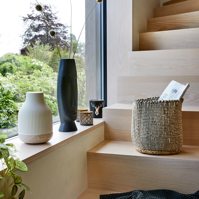 diffuser in window next to stair surrounded by home decor