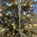 Decorative icicle ornament on a Christmas tree with lights